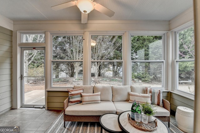 sunroom / solarium featuring a ceiling fan and a wealth of natural light