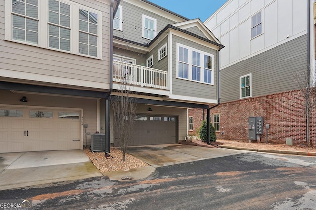 view of front of property featuring central air condition unit and a garage
