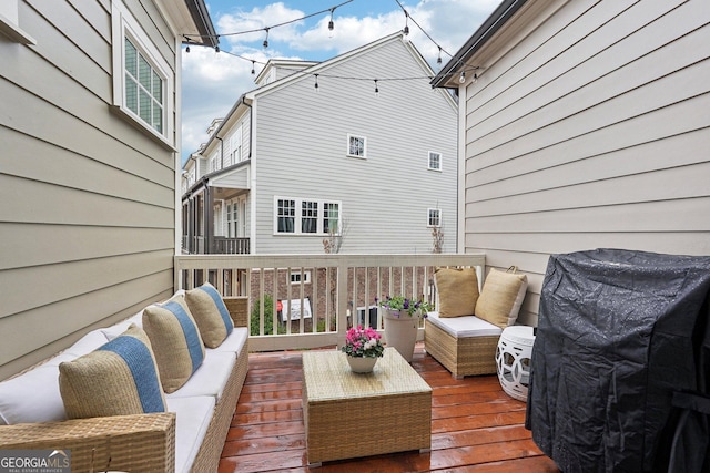 wooden terrace featuring an outdoor living space and grilling area