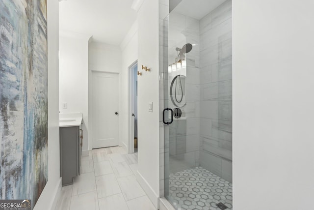 bathroom featuring a shower stall, vanity, baseboards, and ornamental molding