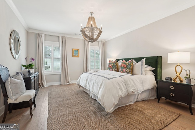 bedroom featuring baseboards, wood finished floors, and crown molding