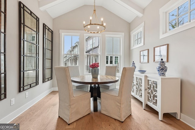 dining space featuring light wood-style flooring, plenty of natural light, and a chandelier
