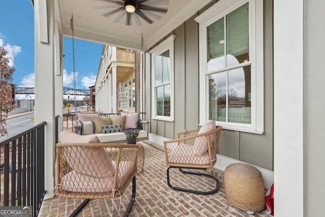 balcony with an outdoor living space and a ceiling fan