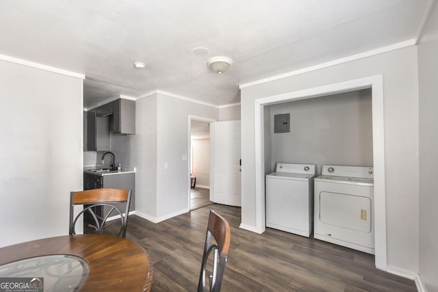 dining area featuring crown molding, dark wood finished floors, washing machine and dryer, electric panel, and baseboards