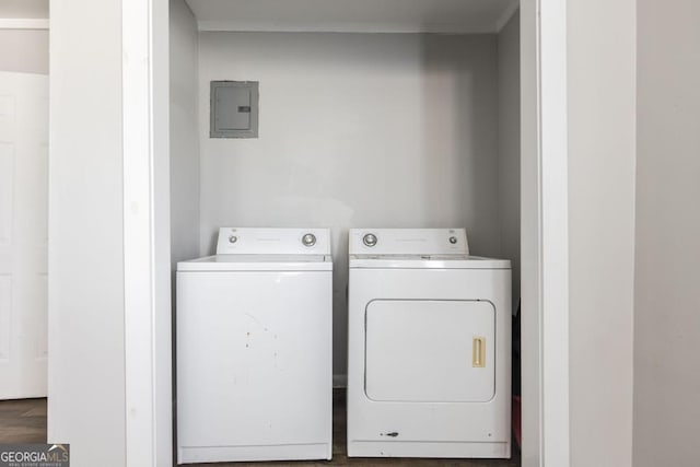 laundry area featuring laundry area, washer and clothes dryer, wood finished floors, and electric panel