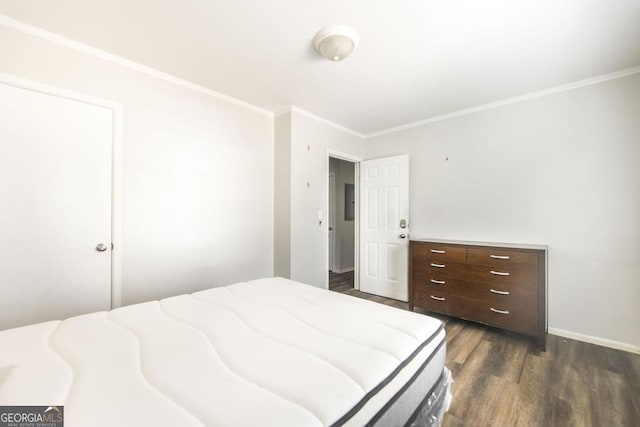 bedroom featuring crown molding, baseboards, and dark wood-type flooring