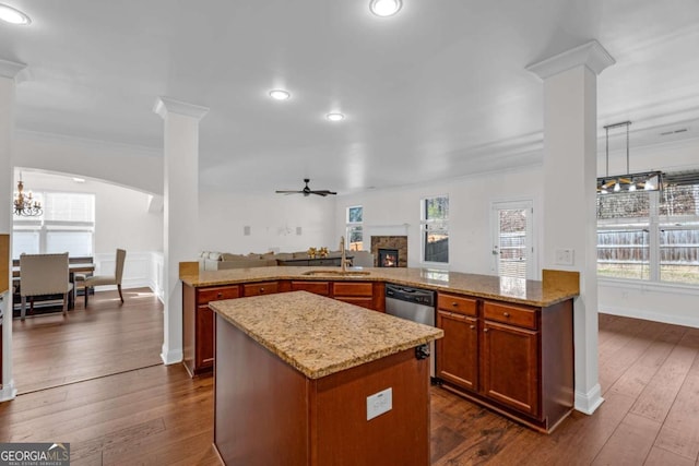 kitchen featuring ornamental molding, a sink, ornate columns, and ceiling fan with notable chandelier