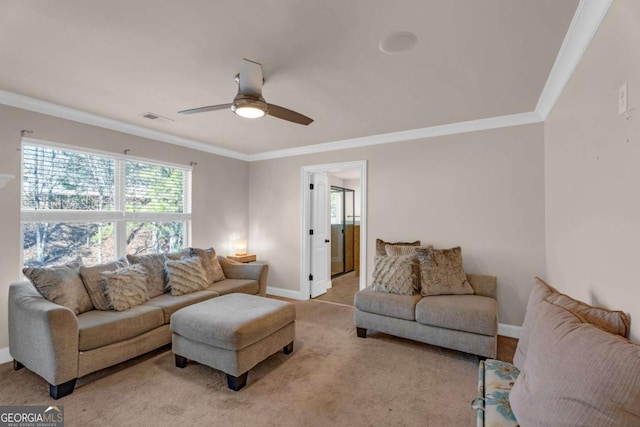 living room featuring carpet, visible vents, baseboards, and ornamental molding