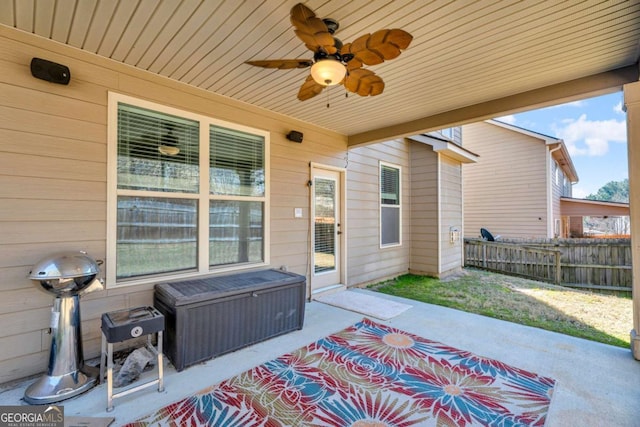 view of patio / terrace featuring ceiling fan and fence