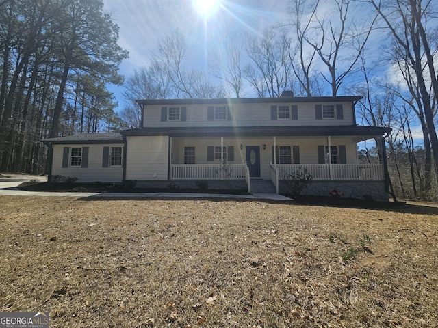 view of front of home with covered porch and a chimney