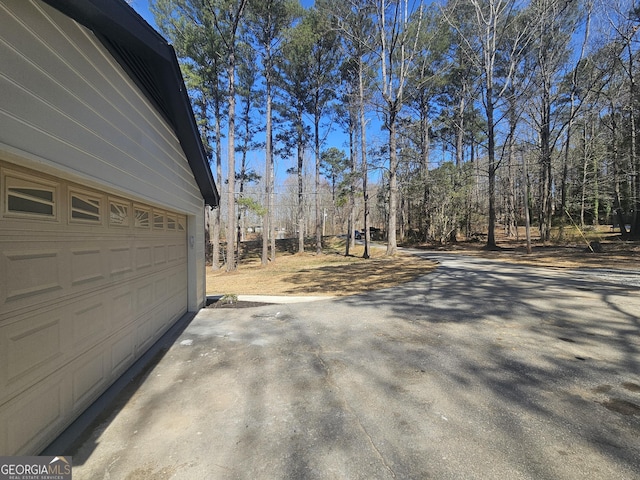 exterior space with a garage and concrete driveway