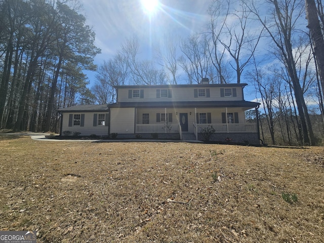 view of front of home with a porch and a chimney