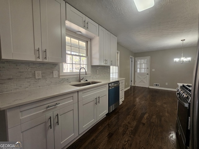 kitchen featuring visible vents, stainless steel dishwasher, white cabinets, a sink, and gas range