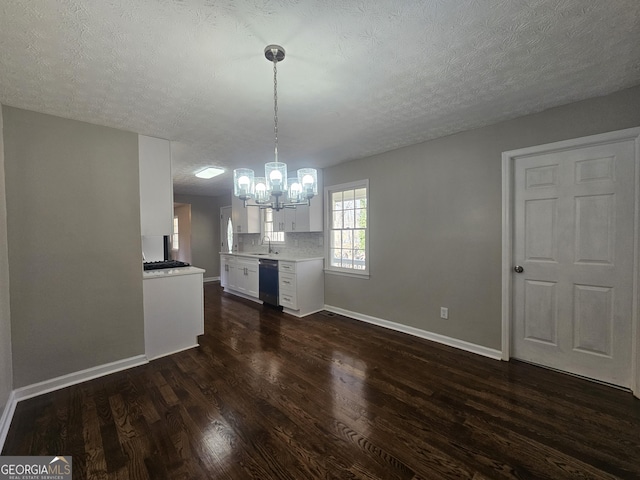 kitchen featuring light countertops, dark wood-type flooring, white cabinets, a sink, and dishwasher