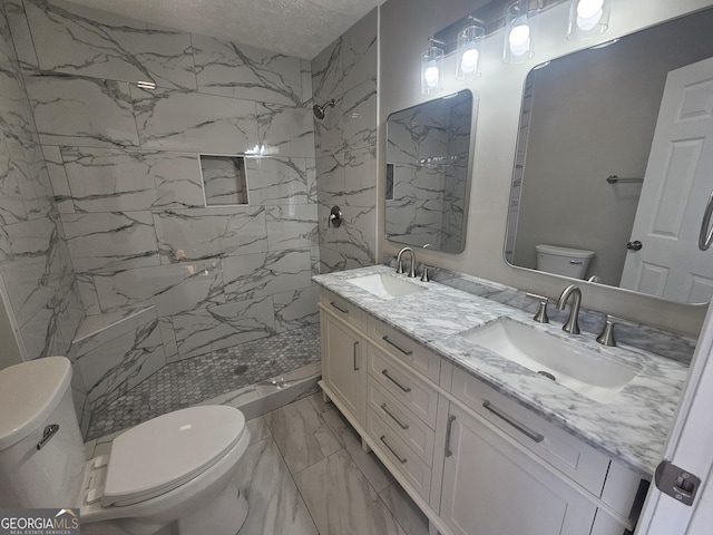 full bath featuring toilet, marble finish floor, a marble finish shower, and a sink