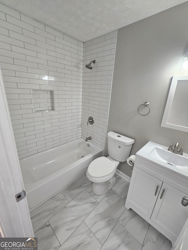 bathroom featuring a textured ceiling, toilet, vanity, marble finish floor, and shower / bathing tub combination