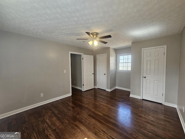 unfurnished bedroom featuring ceiling fan, a textured ceiling, baseboards, and wood finished floors