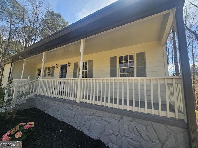 view of side of home featuring a porch