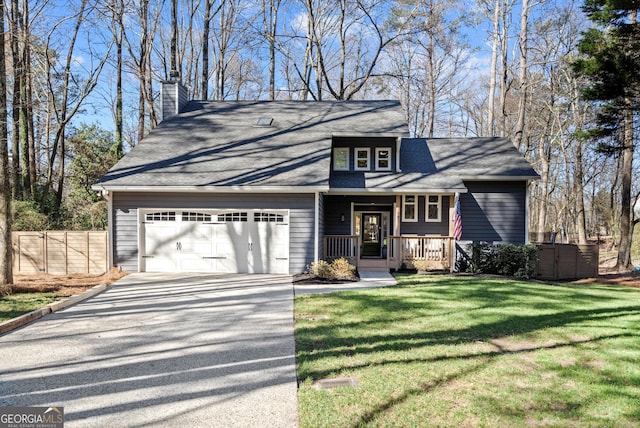 view of front of property with a front yard, fence, a porch, an attached garage, and concrete driveway