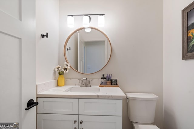 half bathroom with toilet and vanity