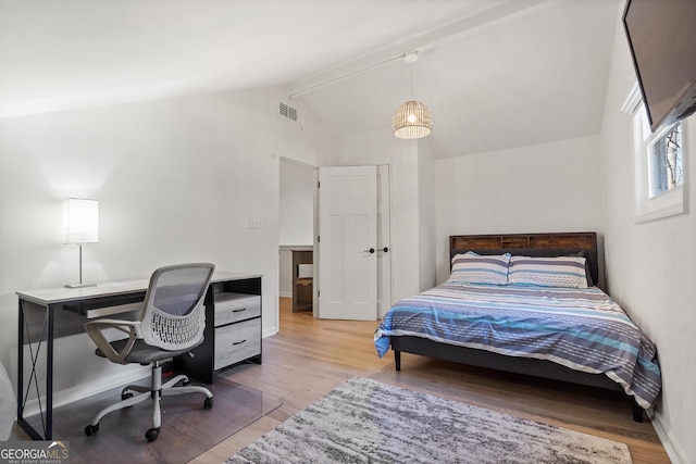 bedroom featuring visible vents, baseboards, wood finished floors, and vaulted ceiling with beams