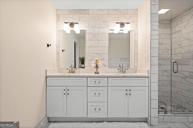 bathroom featuring a sink, double vanity, and a shower stall