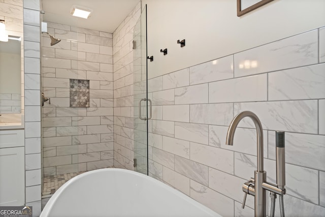 bathroom with a shower stall and a freestanding bath