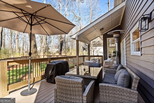 wooden terrace featuring grilling area and an outdoor living space