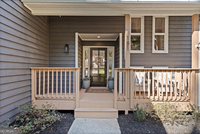 view of exterior entry with a porch