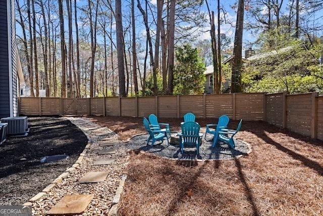 view of yard featuring a fire pit and a fenced backyard