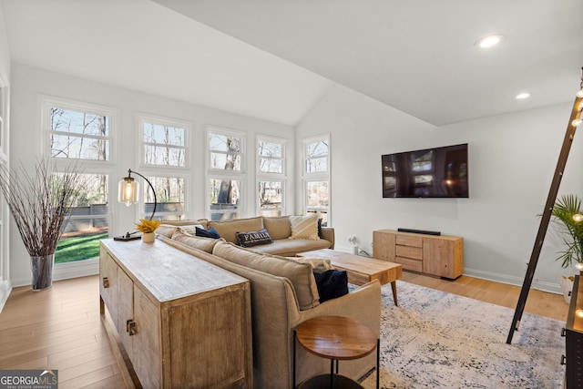 living room with light wood finished floors, recessed lighting, baseboards, and lofted ceiling