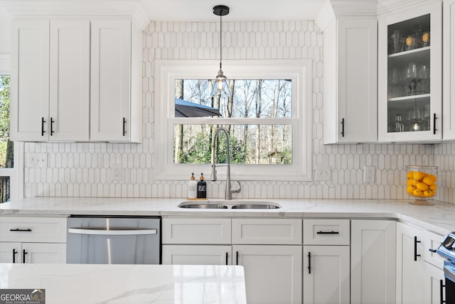 kitchen featuring dishwasher, white cabinets, glass insert cabinets, and a sink