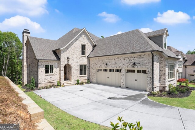 4860 Grandview Ct, Flowery Branch, GA 30542 - french provincial home with brick siding, an attached garage, roof with shingles, and concrete driveway