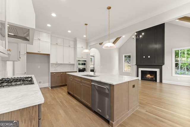 4860 Grandview Ct, Flowery Branch, GA 30542 - kitchen featuring lofted ceiling, appliances with stainless steel finishes, a sink, white cabinets, and light wood-type flooring