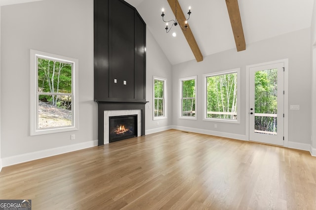 4860 Grandview Ct, Flowery Branch, GA 30542 - unfurnished living room with high vaulted ceiling, a chandelier, a large fireplace, baseboards, and light wood-style floors