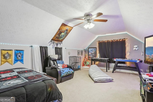 bedroom with lofted ceiling, ceiling fan, a textured ceiling, and carpet