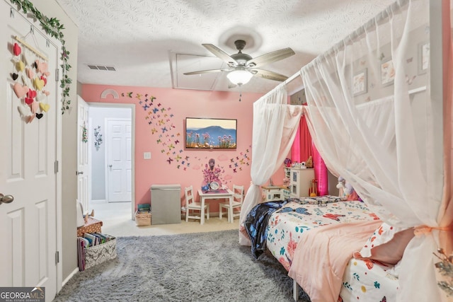 carpeted bedroom featuring visible vents, ceiling fan, and a textured ceiling