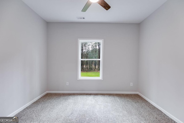 unfurnished room with baseboards, visible vents, ceiling fan, and carpet flooring