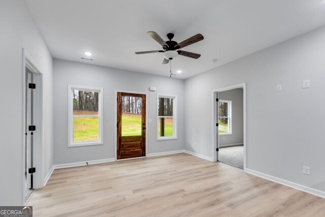 foyer entrance featuring light wood-type flooring, a wealth of natural light, baseboards, and recessed lighting