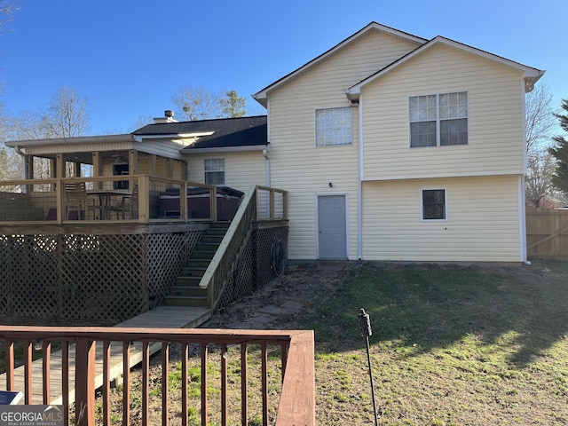 rear view of house featuring a yard, stairs, fence, and a wooden deck