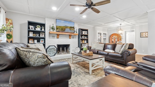 living room with a fireplace, ceiling fan, wood finished floors, coffered ceiling, and baseboards