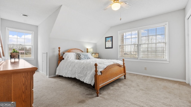 carpeted bedroom with visible vents, baseboards, lofted ceiling, ceiling fan, and a textured ceiling