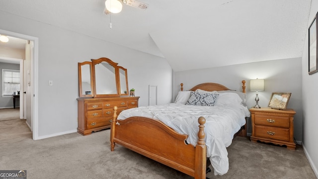 carpeted bedroom with a ceiling fan, lofted ceiling, and baseboards