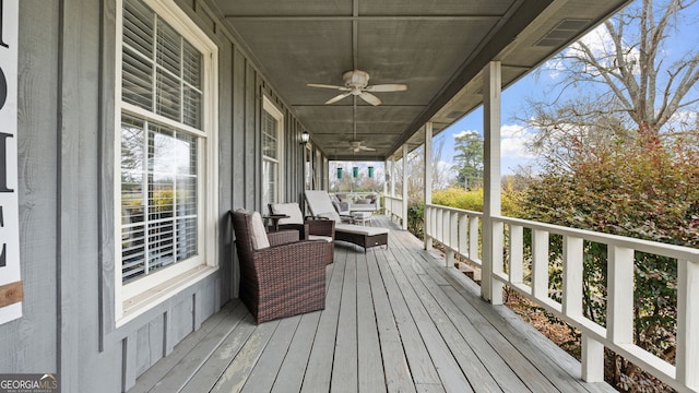 wooden terrace featuring a ceiling fan and covered porch