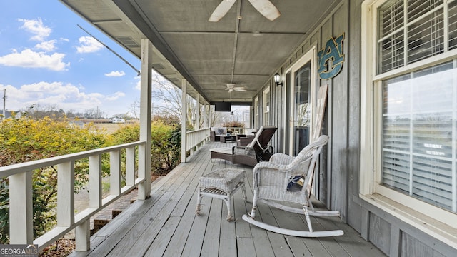 wooden terrace featuring a porch and a ceiling fan