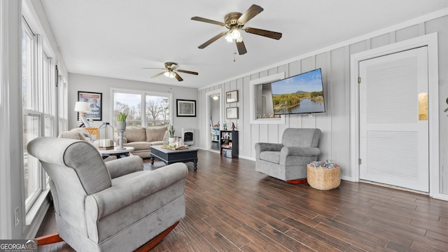 living room featuring dark wood-style floors, a fireplace, and baseboards