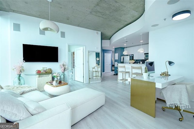 living area with visible vents and light wood-style floors