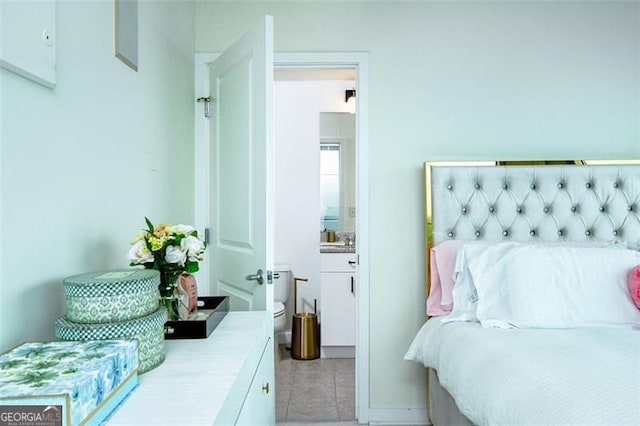 bedroom featuring tile patterned flooring and connected bathroom