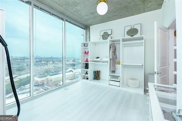 361 17th St Unit 2122, Atlanta, GA 30363 - unfurnished bedroom featuring wood finished floors and expansive windows