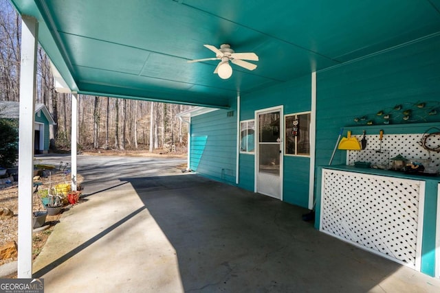 view of patio / terrace featuring a ceiling fan and a carport